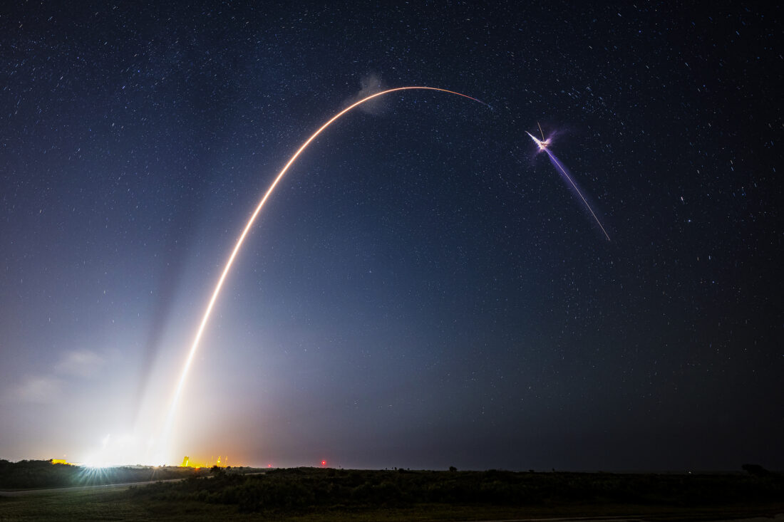 A rocket launches into a night sky